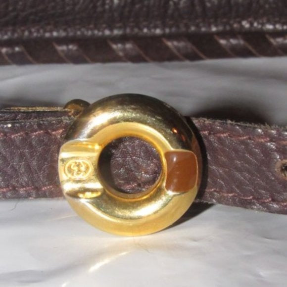 Early,  , Gucci, brown whip-stitched, leather belt with a round, gold & enamel buckle
