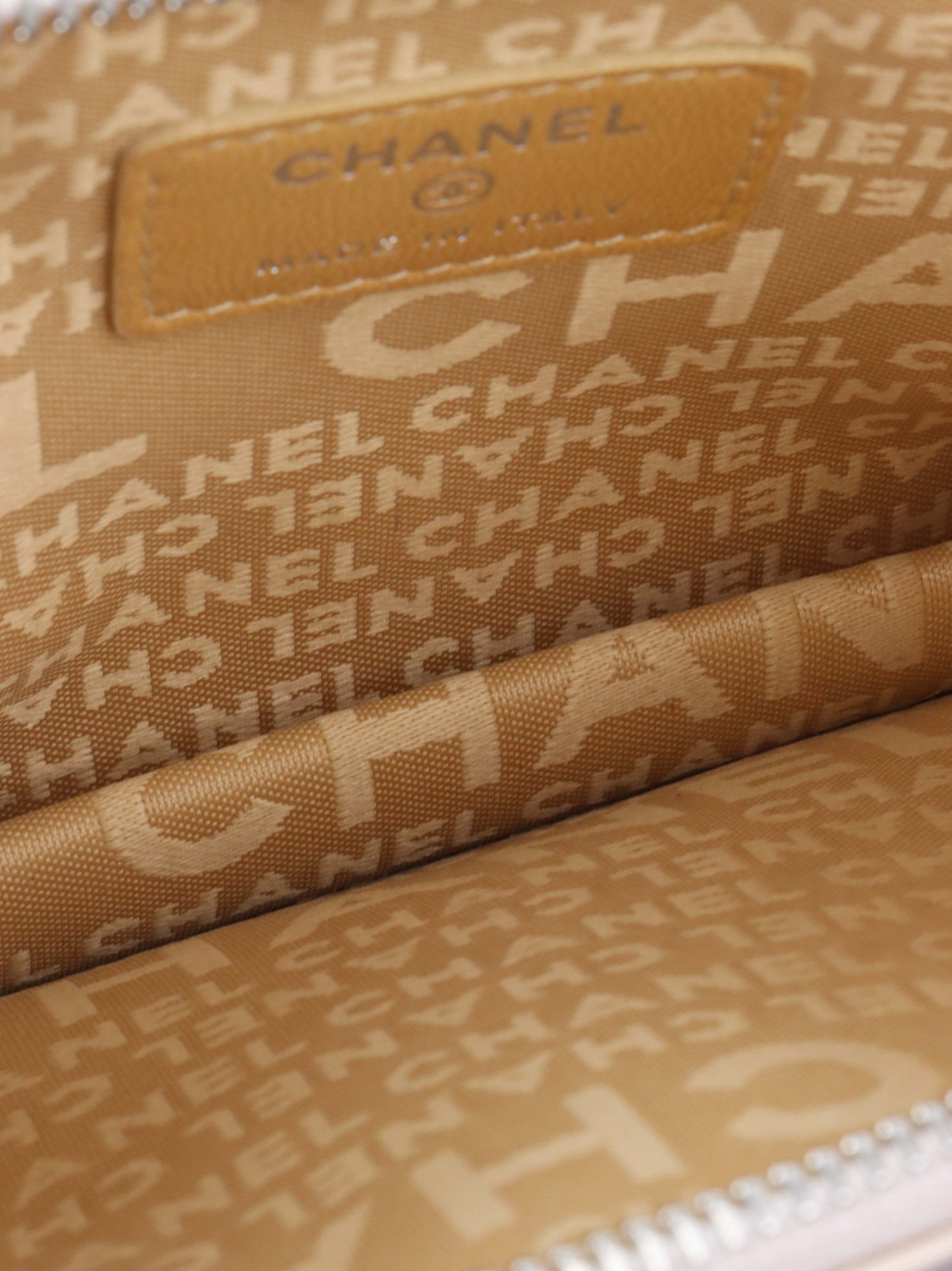 Chanel Beige Lucky Embossed Symbols Pochette with Wristlet Chain.