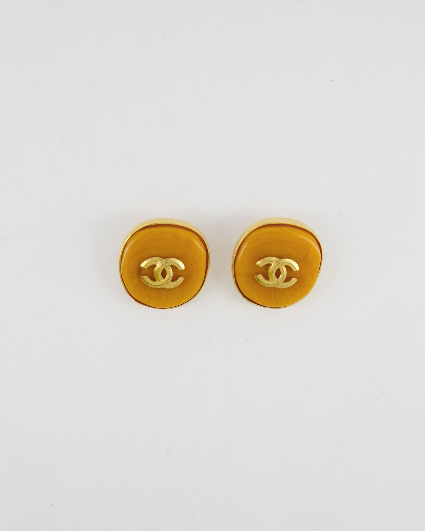 Chanel   98P Orange Rounded Clip On Earrings with Gold Rim and CC Logo Detail