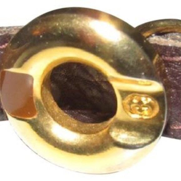 Early,  , Gucci, brown whip-stitched, leather belt with a round, gold & enamel buckle