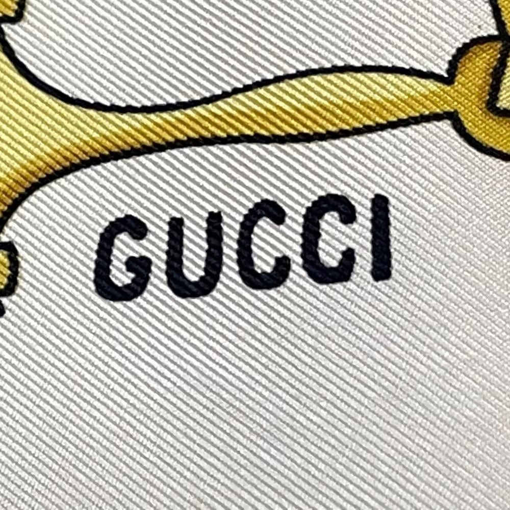 , Gucci, equestrian print, 35" square, 100 % silk scarf in brown, gold, & black on a white background with a wide brown border