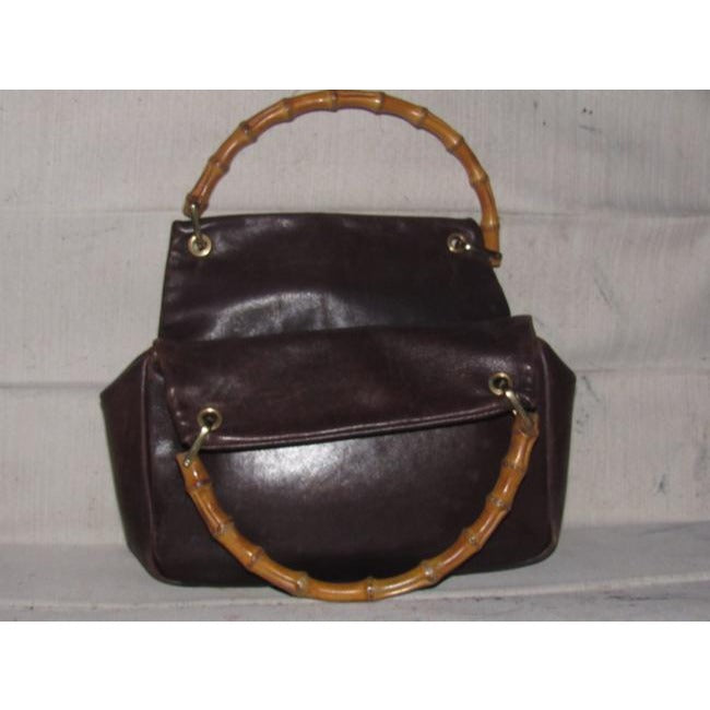 Gucci, mod look, supple brown leather satchel style bag with two bamboo handles & accents, gold tone hardware, a center zip closure