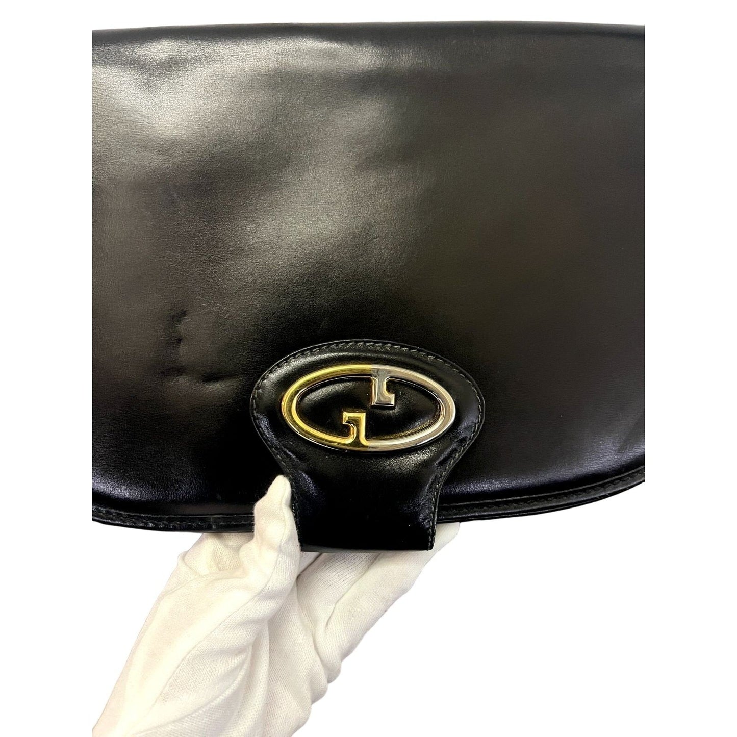 , rare, black leather, Gucci shoulder bag with a large, two-tone 'GG' emblem and removable strap